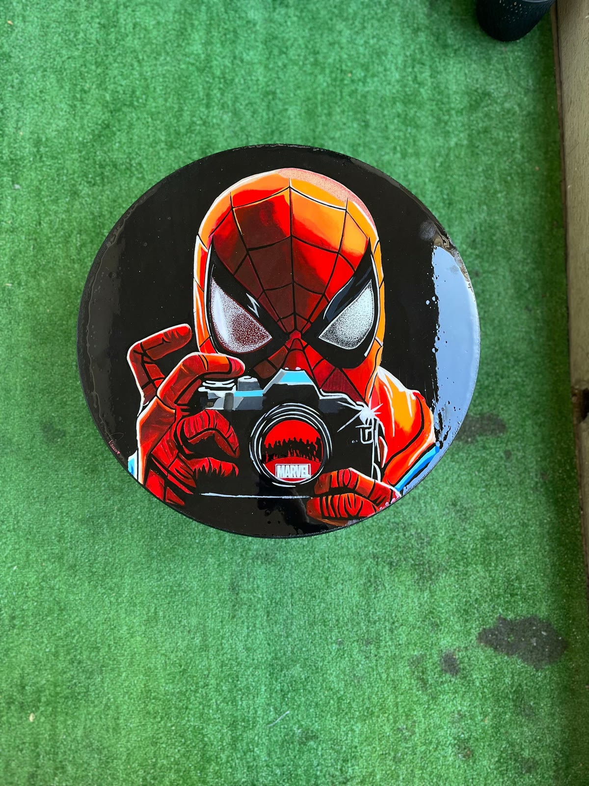 The round tabletop, photographed on grass.